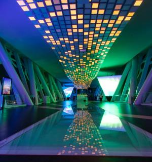 a hallway of a building with a ceiling with lights
