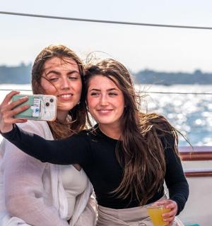 a man and a woman taking a picture on a boat