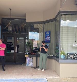 a group of people standing outside of a store