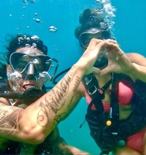 two people in the water wearing a gas mask