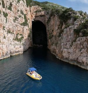 a small boat in front of a tunnel in the water
