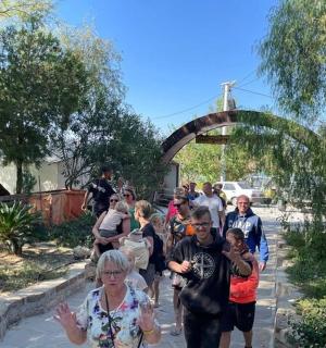 a group of people walking down a sidewalk