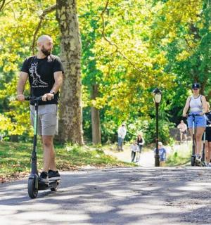 a man riding a scooter in a park
