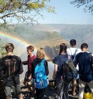 一群人站在彩虹前