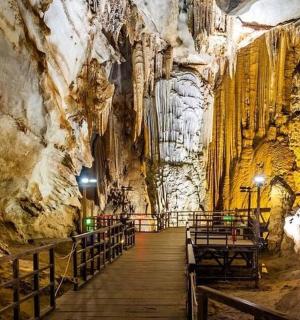 a hallway in a cave with a rock wall