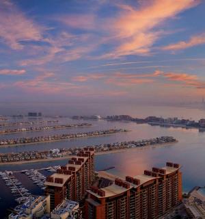 an aerial view of a marina with buildings and boats