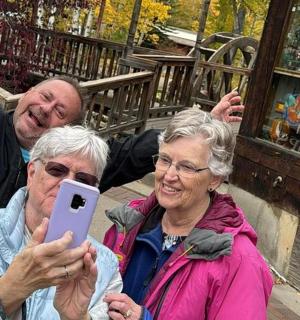 a man and a woman taking a picture with a cell phone