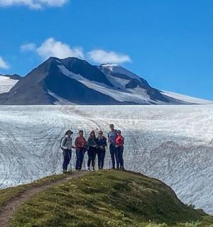 a group of people standing on top of a mountain