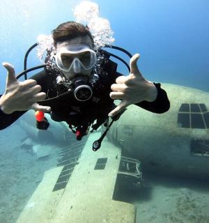 a person in a diving mask giving the thumbs up