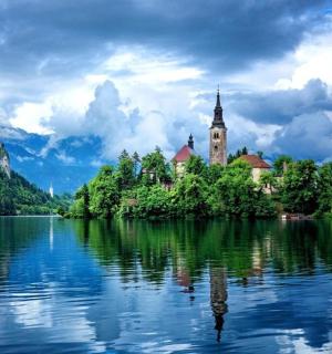an island in the middle of a lake with a church