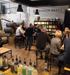 a group of people sitting at tables in a wine store
