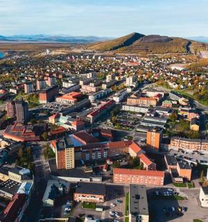 an aerial view of a city with a mountain