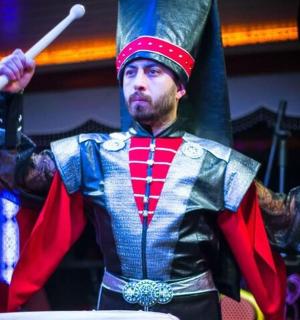 a man in a costume with a flag on his head