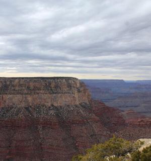 a view of the grand canyon under a cloudy sky