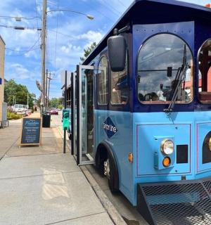 a blue bus parked on the side of a street