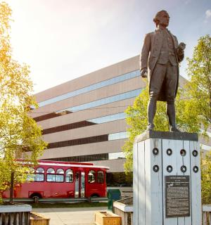 a statue of a man standing on top of a monument