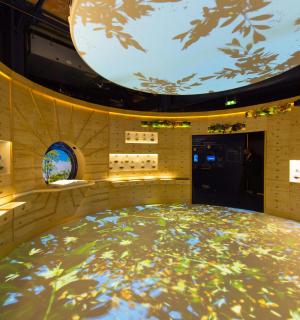 a large circular room with a large orb on the ceiling