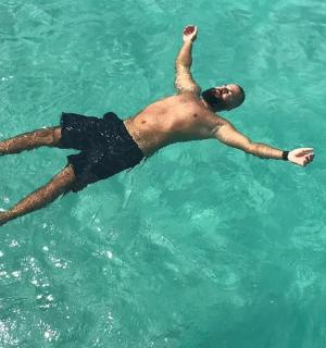 a man laying in the water in the ocean