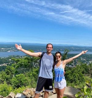 a man and a woman standing on top of a mountain