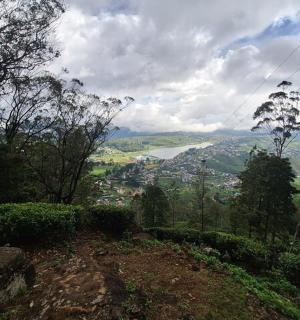 a person sitting on a hill looking at a valley