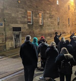 a crowd of people standing outside of a building