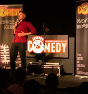 a man standing on a stage with a microphone