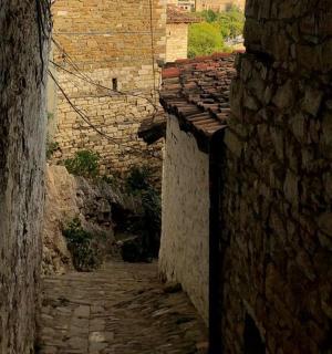 an alley in an old town with stone buildings