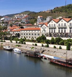 a city with boats docked in a river with buildings