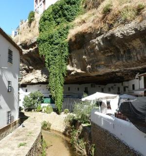 a group of buildings next to a mountain