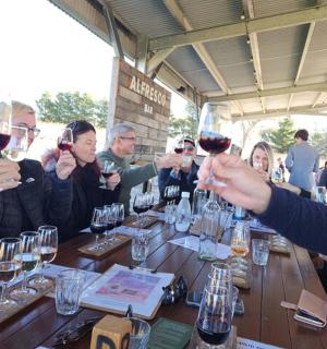 a group of people holding up glasses of wine