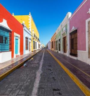 an empty street with colorful buildings in a city