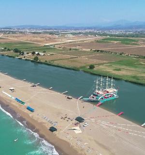 a boat in the water next to a beach
