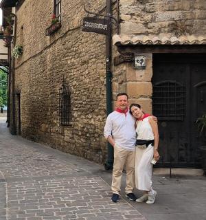 a man and a woman standing in front of a building