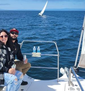 a man and a woman sitting on a sail boat
