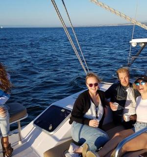 a group of people sitting on a boat in the water