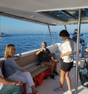 a group of people sitting on the back of a boat