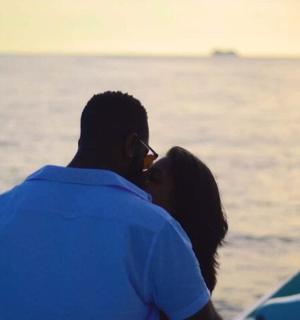 a man and a woman looking at the water