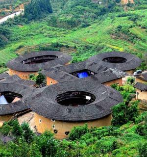 a group of buildings on a hill with trees