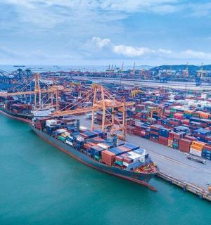 an aerial view of a harbor with a large cargo ship