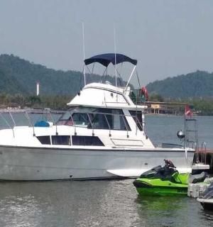 a white boat is docked in the water