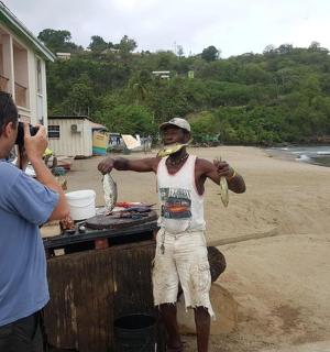 a man taking a picture of a man standing on the beach