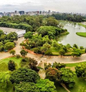 an aerial view of a park with a lake and a fountain