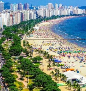 a beach with a crowd of people and the ocean