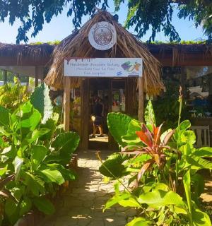 a small hut with a sign in front of it