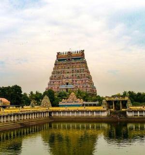 a large building in front of a body of water