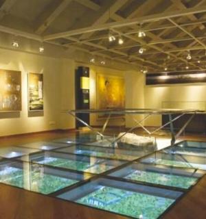 a museum with a glass floor in a room