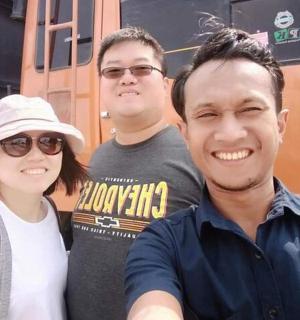 a group of three people standing in front of a train