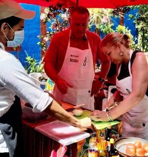 a man and a woman preparing food in a kitchen