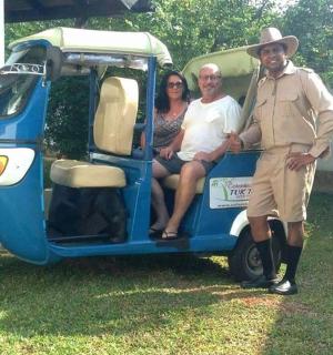 a group of people sitting in the back of a small golf cart