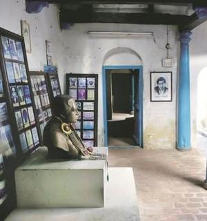 博物馆里坐在长椅上的男子雕像